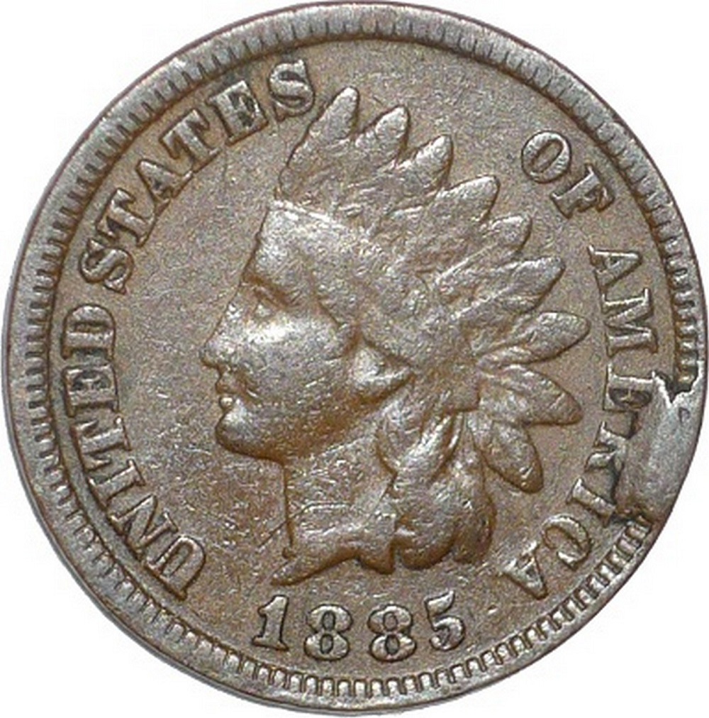 1885 Indian Head Penny die cud error showing raised blob of copper at the rim from a die break
